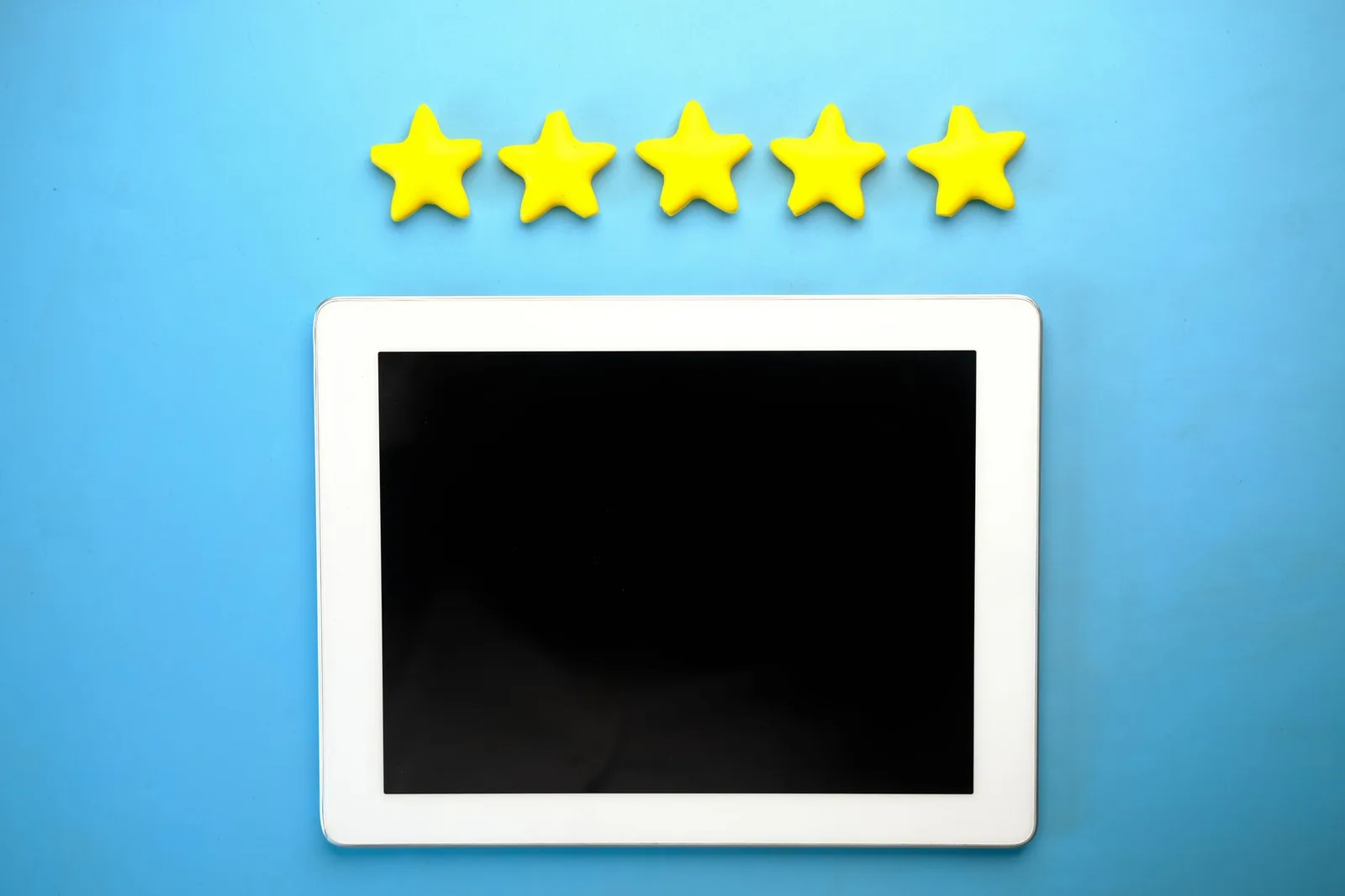 A tablet screen showing a row of five yellow stars against a blue background.